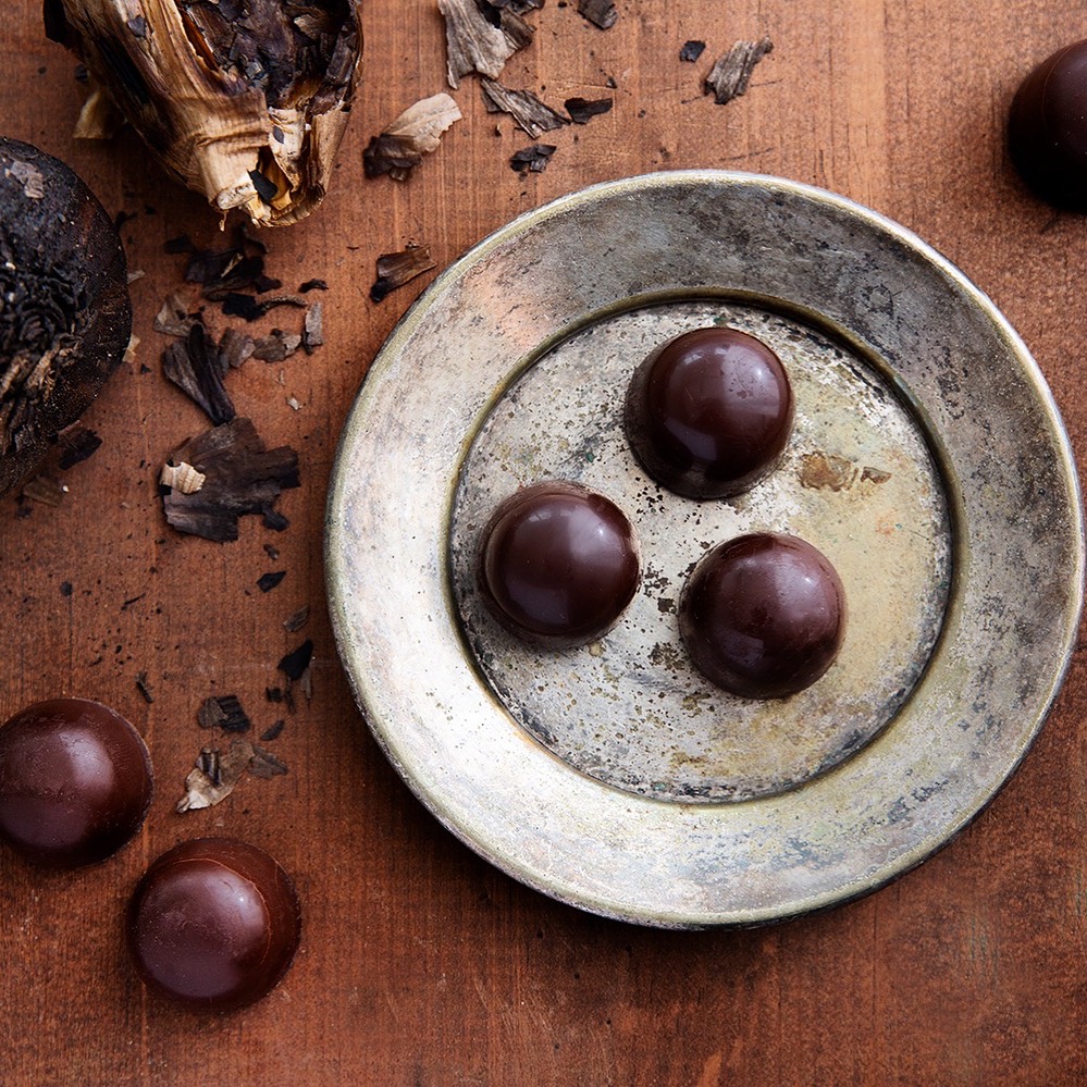 and elegant chocolate flavored bonbon made with dark chocolate, fermented black garlic, sesame seeds and black lava salt