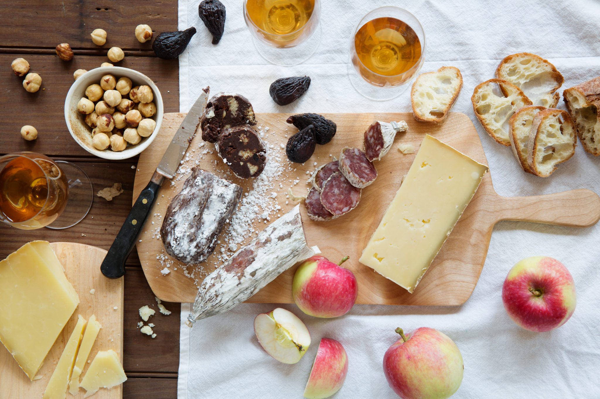 cheese, chocolate charcuterie, and salami with nuts and french bread