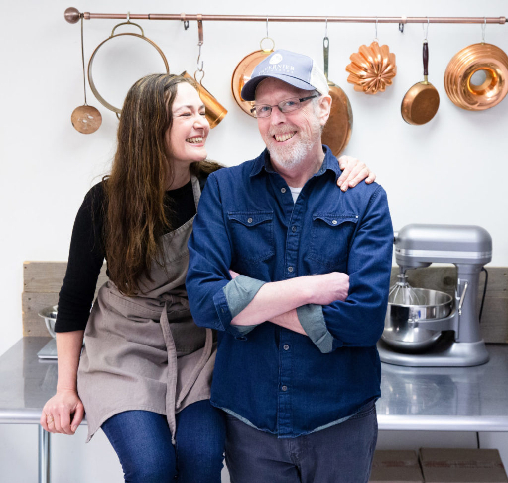 Vermont chocolatiers Dar Tavernier-Singer and John Singer of Tavernier Chocolates share a laugh in their kitchen