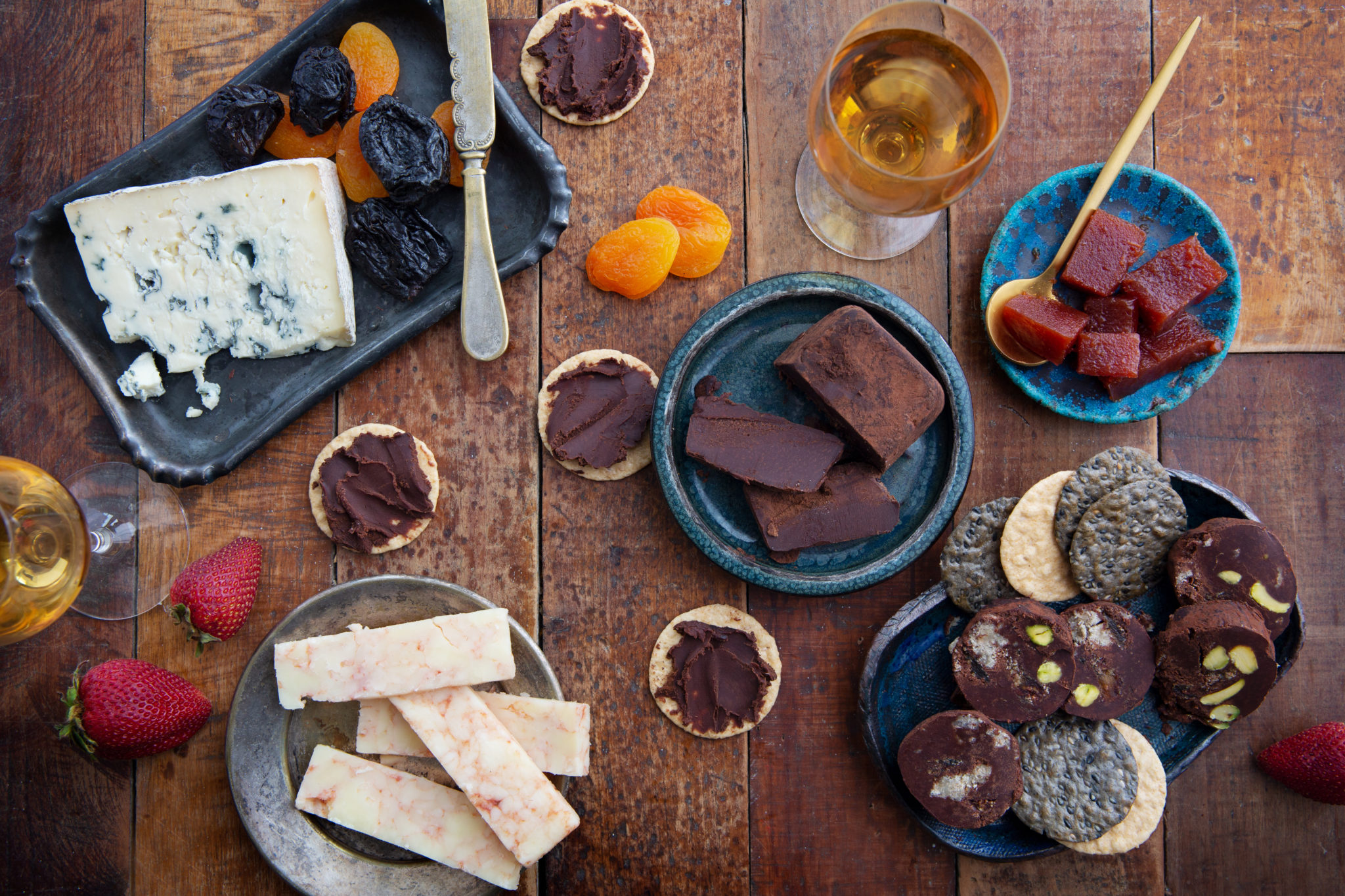 Cheese and chocolate charcuterie laid out on a wooden table