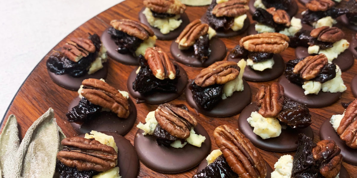 Wooden platters of chocolate and cheese canapes