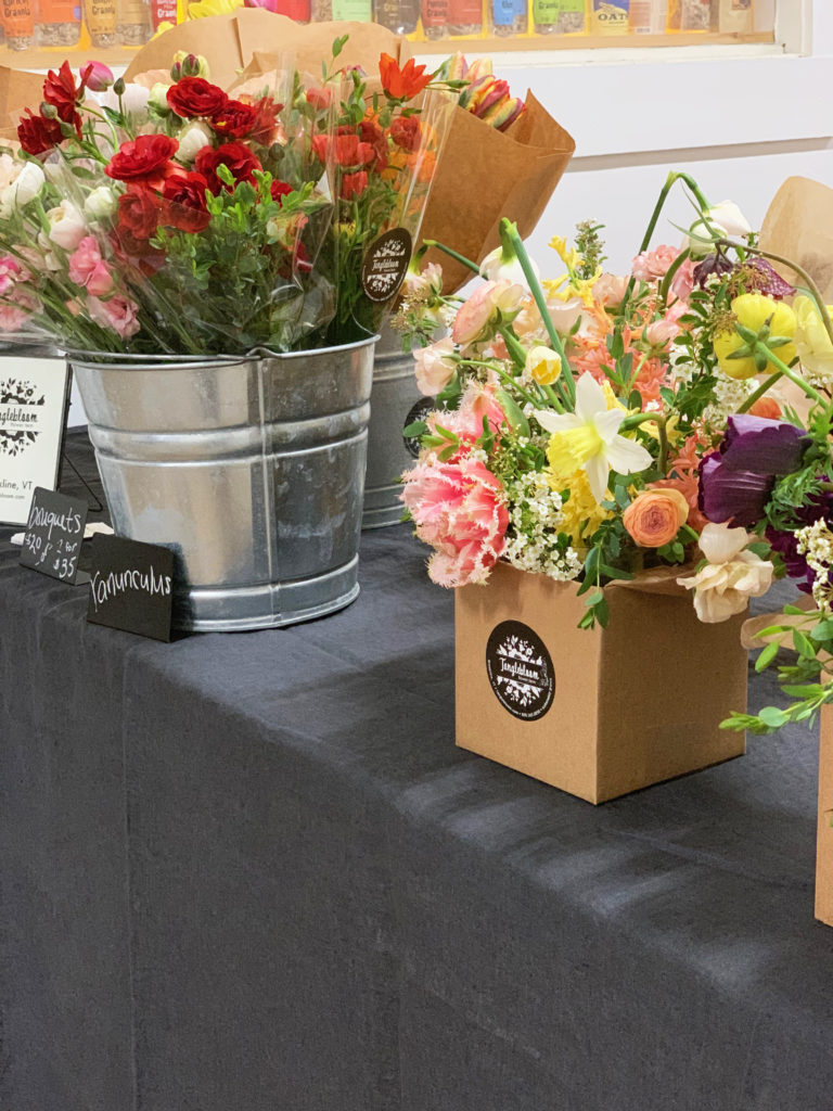 Flower bouquets in boxes and milk buckets