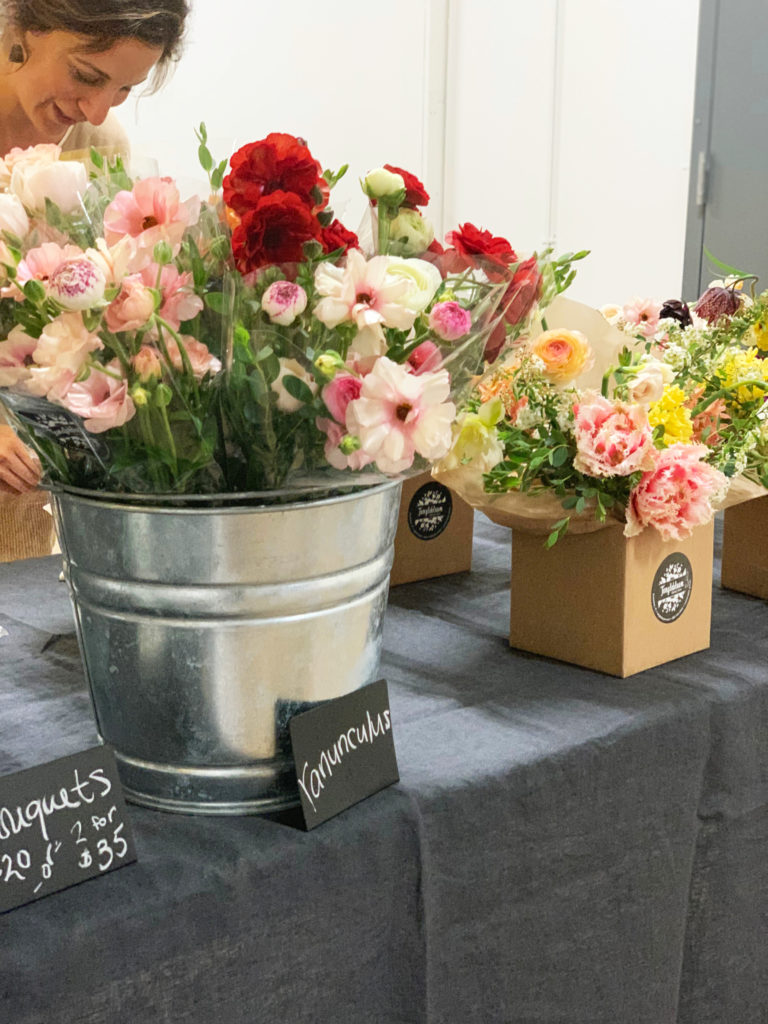 Flower bouquets in boxes and milk buckets