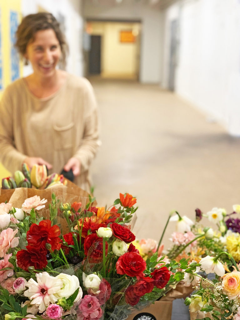 flower bouquets with a woman laughing in the background