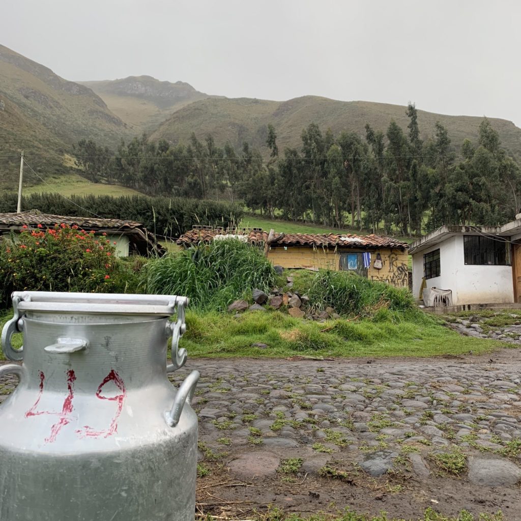 milk can in front of houses in a dairy farming village in the Ecuadorian Andes