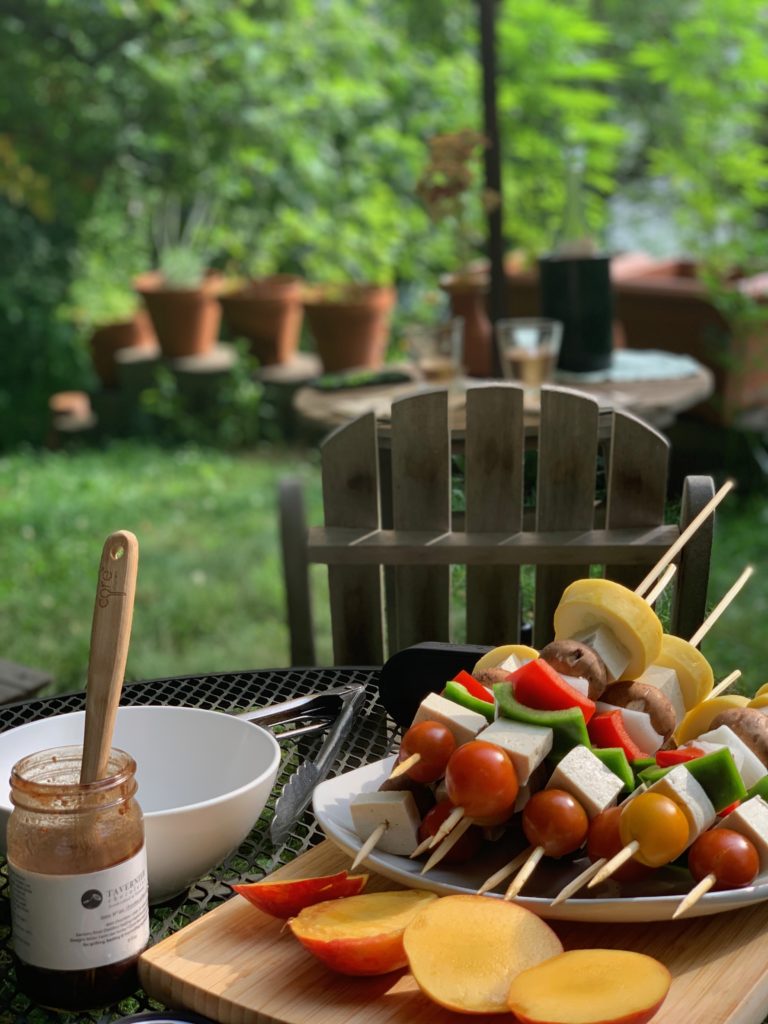 uncooked kababs, peaches, and a jar of Tavernier chocolate