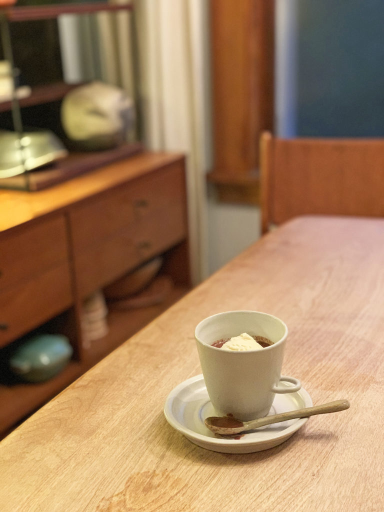 affogato in a small mug with stirring spoon