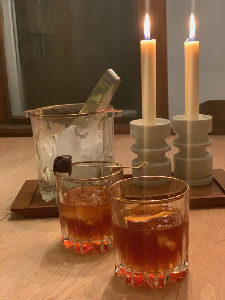 Spiced creme de cacao cocktails in whiskey glasses with an orange garnish