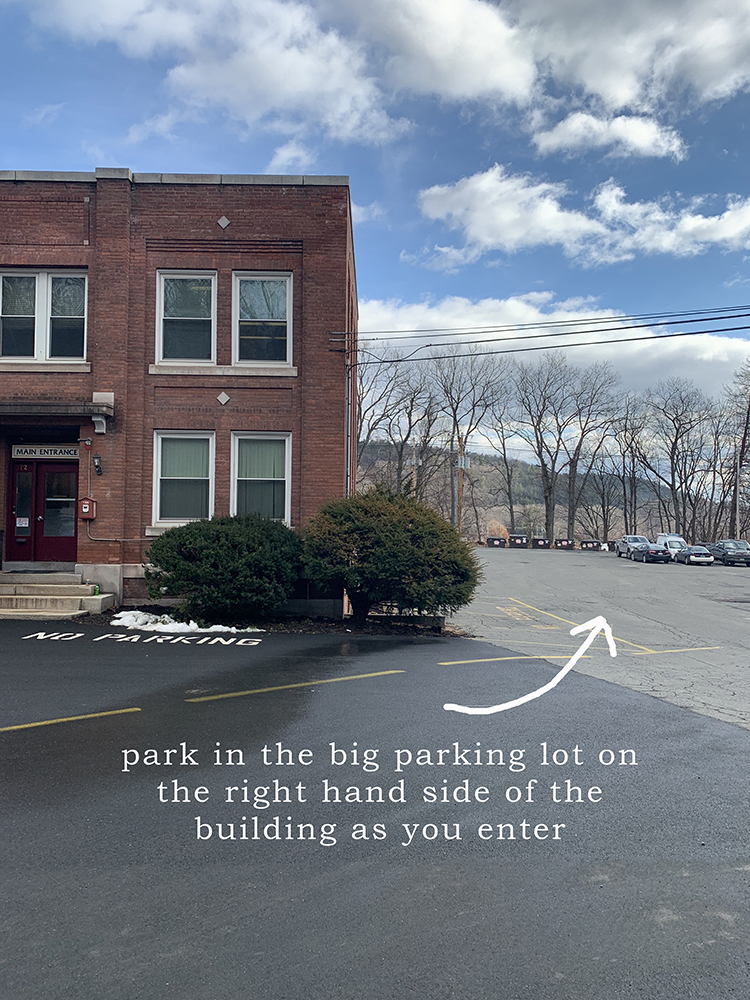 Park in the big parking lot on the right hand side of the Cotton Mill building as you enter