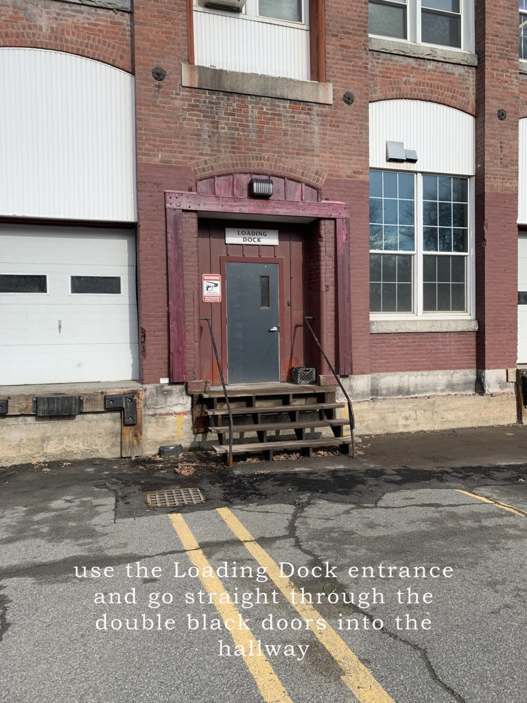 Use the loading dock entrance and go straight through the double black doors into the hallway