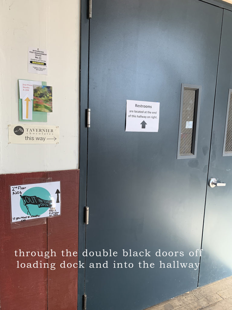 Through the double black doors off leading dock and into the hallway