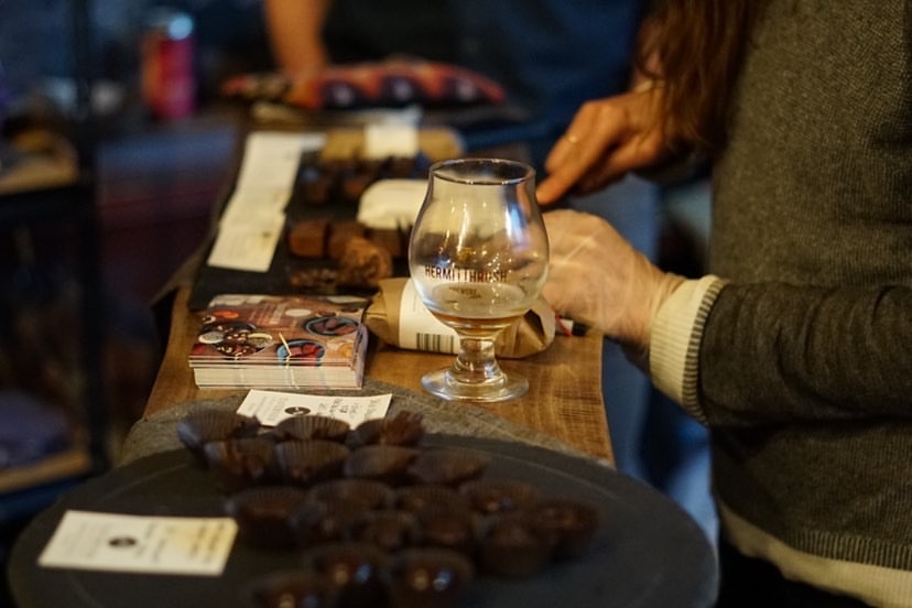 Dar Singer slices chocolate charcuterie for an event with Hermit Thrush