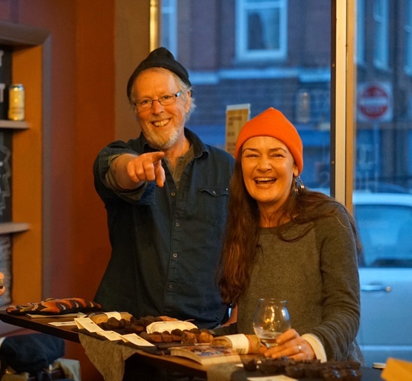 John and Dar Singer smiling and laughing at an event at Hermit Thrush Brewery