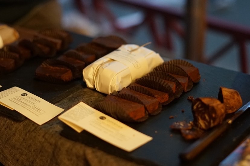 Wooden board with various types of Tavernier chocolates laid out