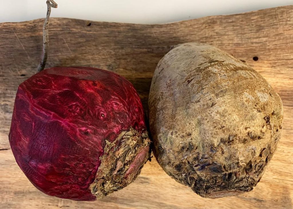 Two red beets, one peeled