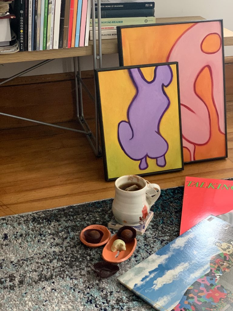 Tea and bonbons in front of two pieces of bright art