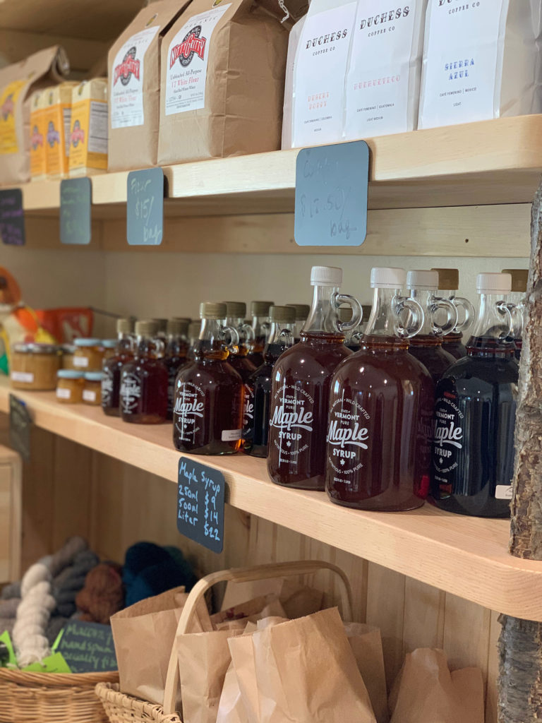 wooden shelves featuring Vermont maple syrup, Duchess coffee, and yarn