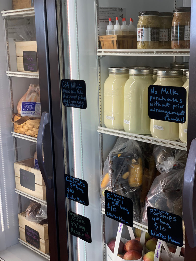 Glass refridgerator featuring CSA Milk, carrots, beets, and parsnips