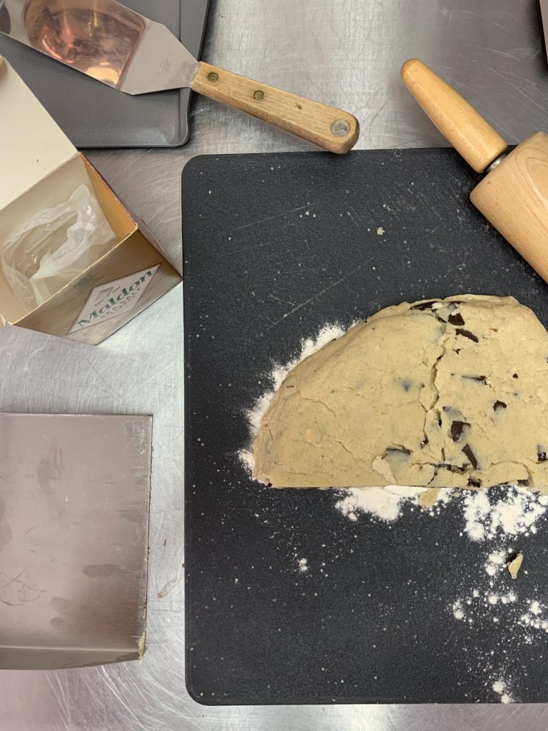 Salted chocolate chunk porcini rosemary shortbread in progress. The dough is shown after being rolled out