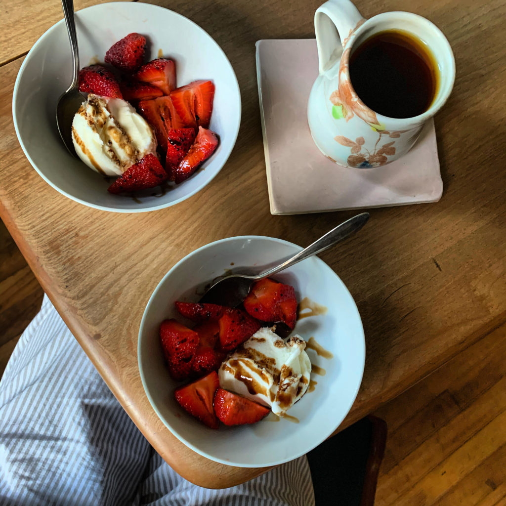 Two bowls of salted chocolate chunk porcini rosemary shortbread with strawberries