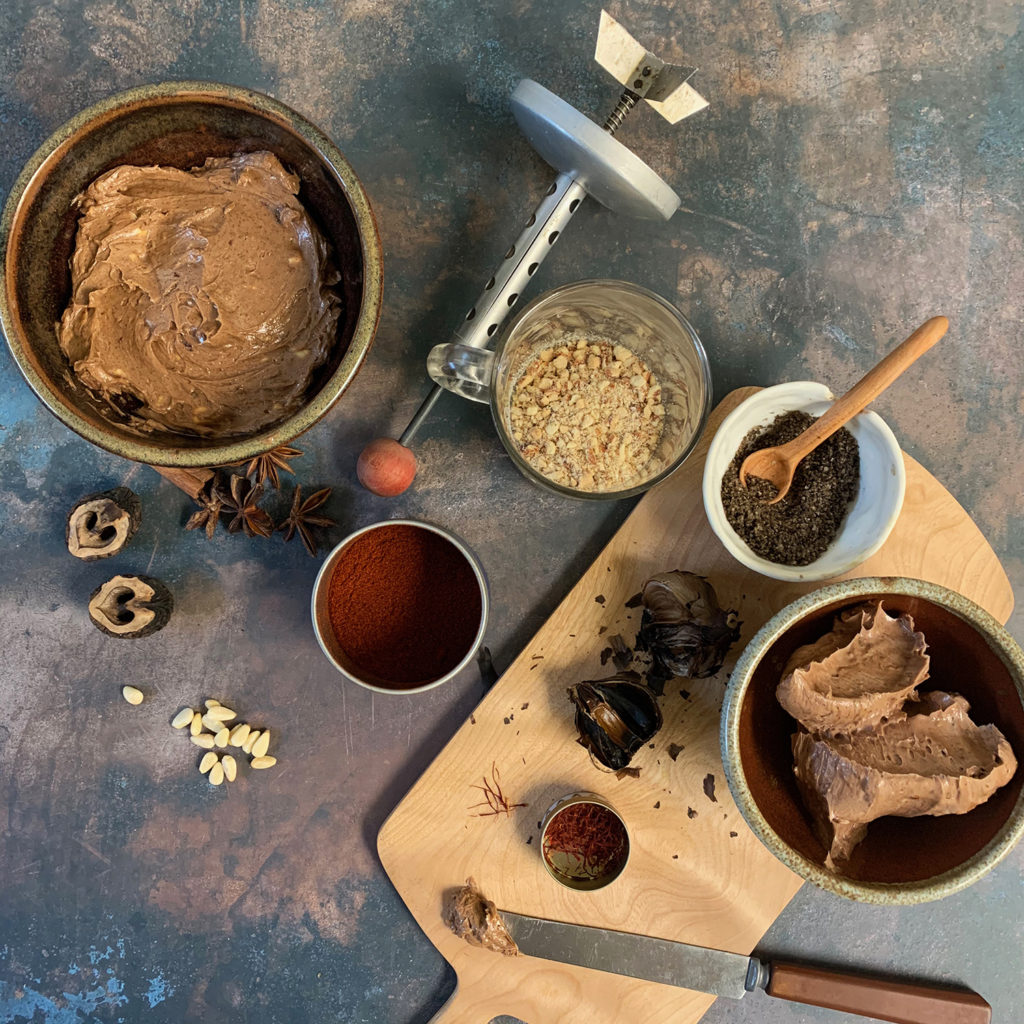 Mole butter in a ceramic dish with star anise and spices