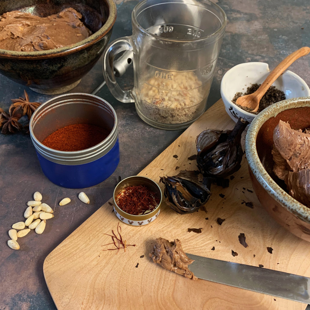 Mole butter in a ceramic dish with star anise and spices