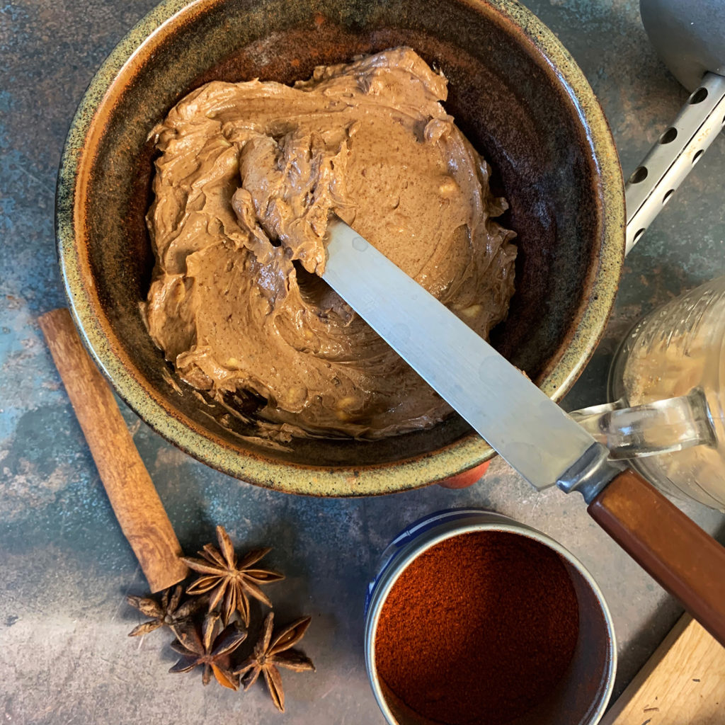 Mole butter in a ceramic dish with star anise and spices