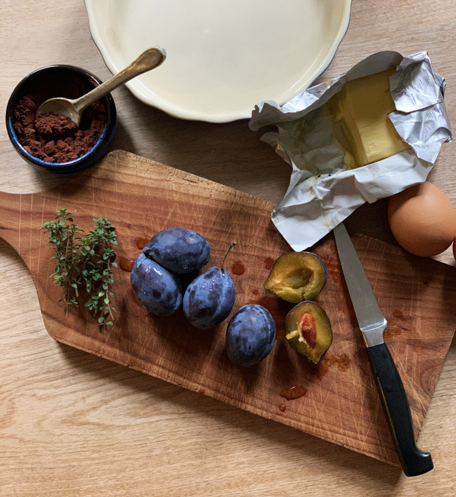 wooden cheese board topped with fresh figs and thyme