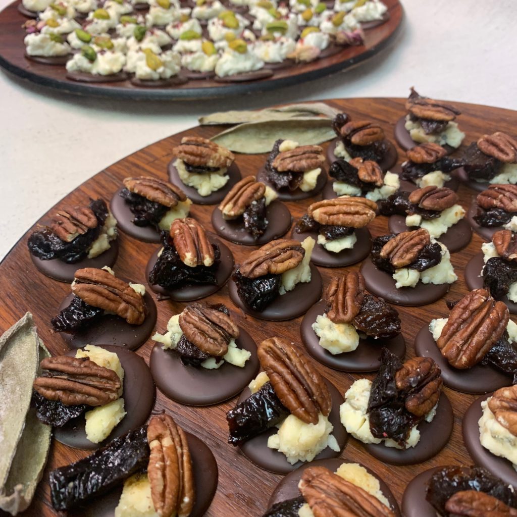 Two wooden platters feature Tavernier's chocolate and cheese canapes. 