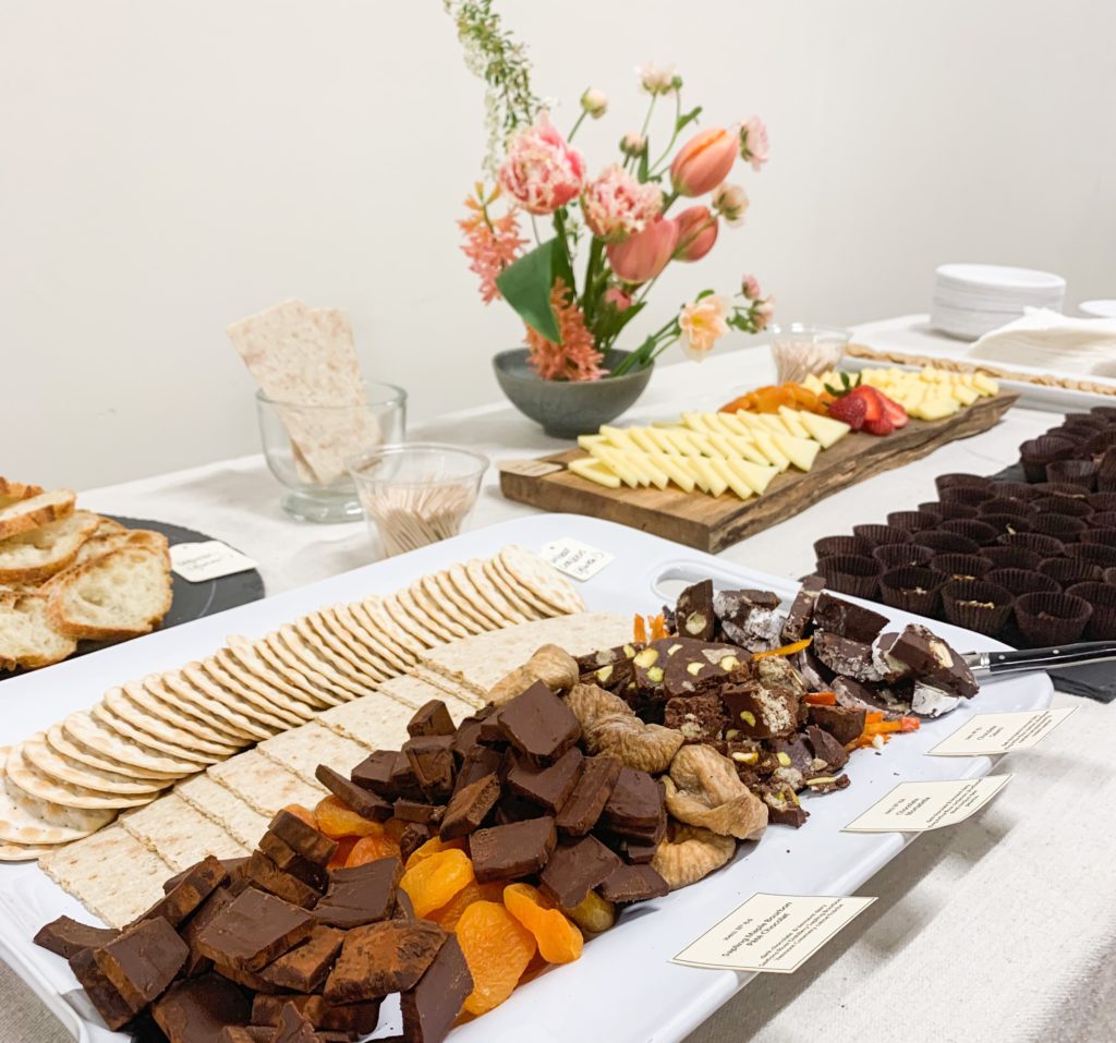 A table with canapes including Tavernier chocolates, dried fruit and water crackers. 