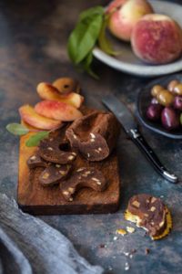 chocolate charcuterie sliced on a wooden board with peaches