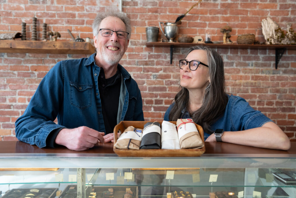 Dar Tavernier and JOhn Singer in their main street chocolate shop in brattleboro vermont